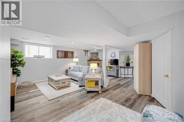 Waterdown apartment for rent - A well-lit, spacious living room with a white sofa set and a coffee table.