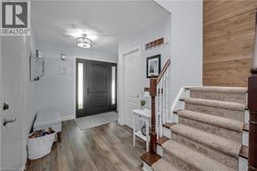 Waterdown apartment for rent - A hallway with a staircase and a white bench.