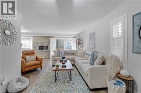 Waterdown apartment for rent - A living room with a fireplace and a couch.