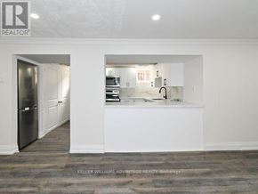 Toronto (Clairlea-Birchmount) apartment for rent - A kitchen with white cabinets and a refrigerator.