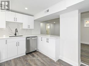 Toronto (Clairlea-Birchmount) apartment for rent - A white kitchen with a stainless steel dishwasher and white cabinets.
