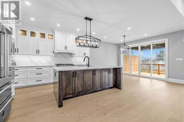 Innisfil (Stroud) apartment for rent - A modern kitchen with white cabinets and a wooden island.