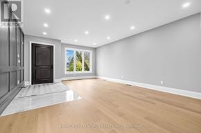 Innisfil (Stroud) apartment for rent - A spacious room with a fireplace and a view of the outdoors through the window.