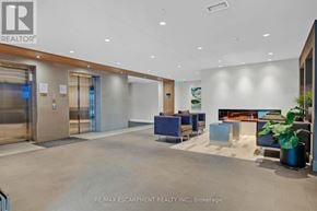 Milton (Fo Ford) condo for rent - A modern office lobby with a reception desk and a plant.