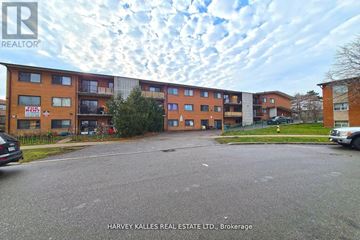 Toronto (Kingsview Village-The Westway) multi-family for rent - A street view of a residential area with apartment buildings and cars parked on the side of the road.