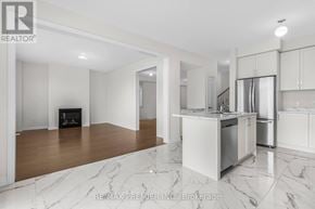 Oshawa (Kedron) apartment for rent - A white kitchen with a refrigerator, oven, and cabinets.