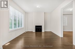 Oshawa (Kedron) apartment for rent - A room with a fireplace and a window with blinds.