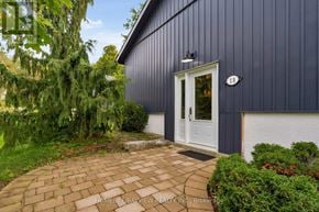 Oro-Medonte (Horseshoe Valley) apartment for rent - A blue house with a white door and a brick pathway leading to it.