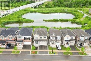 Milton (Cb Cobban) apartment for rent - A row of houses with a pond in the front yard.