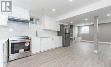 Milton (Cb Cobban) apartment for rent - A modern kitchen with white cabinets and a stainless steel oven.