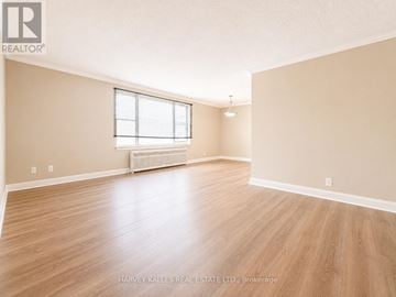 Toronto (Beechborough-Greenbrook) multi-family for rent - A spacious room with wooden flooring and a window.