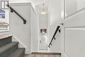 Hamilton (Parkview) townhouse for rent - A hallway with a staircase and a door.