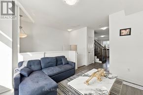 Hamilton (Parkview) townhouse for rent - A living room with a grey couch and a gold lion statue on the coffee table.