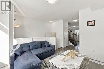 Hamilton (Parkview) townhouse for rent - A living room with a grey couch and a gold lion statue on the coffee table.