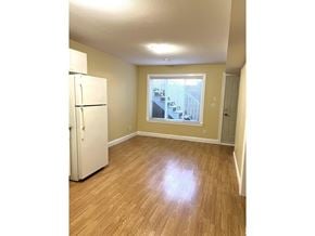 Surrey apartment for rent - A white refrigerator in a room with wooden floors and a window.