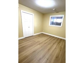 Surrey apartment for rent - A room with a white door and a window with blinds.