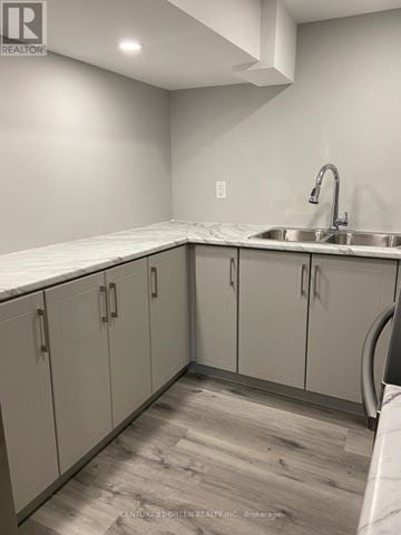 Milton (Sc Scott) apartment for rent - A kitchen with white cabinets and a marble countertop.