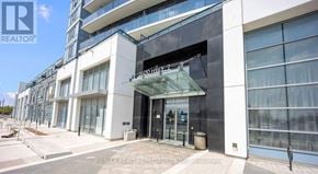 Vaughan (East Woodbridge) condo for rent - The image shows a modern building with a glass entrance and a sign that reads "RE/MAX REALTOR® SPECIALISTS IN PROPERTIES".