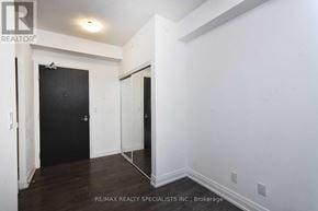 Vaughan (East Woodbridge) condo for rent - A room with a black door and a mirror on the wall.