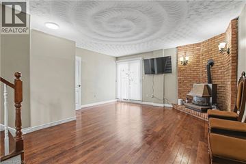 Hamilton apartment for rent - A living room with wood floors and a brick fireplace.