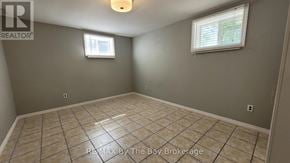 Wasaga Beach apartment for rent - A room with a tiled floor and a window with blinds.