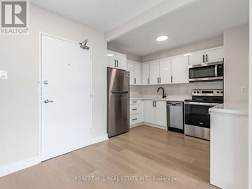 Toronto (Briar Hill-Belgravia) condo for rent - A kitchen with white cabinets and stainless steel appliances.
