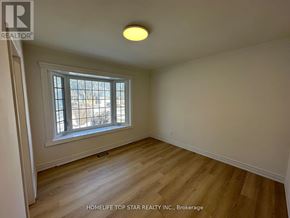 Richmond Hill (Crosby) apartment for rent - A room with a window and wooden flooring.