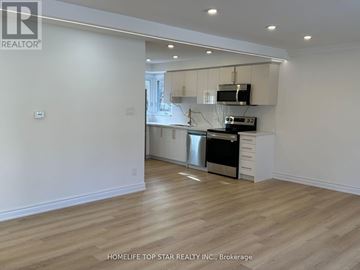 Richmond Hill (Crosby) apartment for rent - A kitchen with white cabinets and a wooden floor.