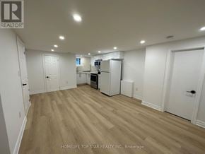 Richmond Hill (Crosby) apartment for rent - A spacious room with wooden flooring and white walls.