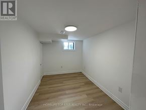 Richmond Hill (Crosby) apartment for rent - A room with wooden flooring and white walls, with a window and a ceiling light.