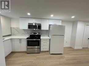 Richmond Hill (Crosby) apartment for rent - A kitchen with white cabinets and stainless steel appliances.