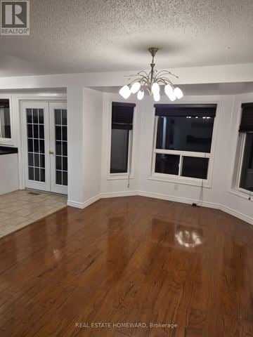 Innisfil (Alcona) apartment for rent - A room with wood flooring and a chandelier.