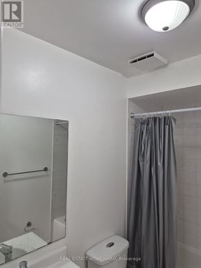 Innisfil (Alcona) apartment for rent - A white bathroom with a toilet, sink, and shower.