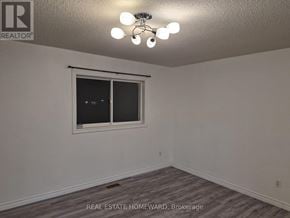 Innisfil (Alcona) apartment for rent - A room with a window and a ceiling light.