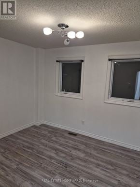 Innisfil (Alcona) apartment for rent - A room with a window and a wooden floor.