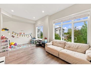 Surrey townhouse for rent - A living room with a white couch and a large window.