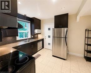 Hamilton apartment for rent - A modern kitchen with a stainless steel refrigerator and black cabinets.