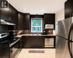 Hamilton apartment for rent - A modern kitchen with black cabinets and stainless steel appliances.