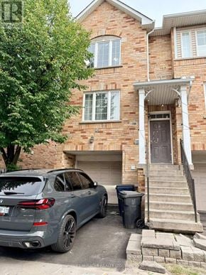 Toronto (Eglinton East) townhouse for rent - A hallway with a staircase on the left and a door at the end.