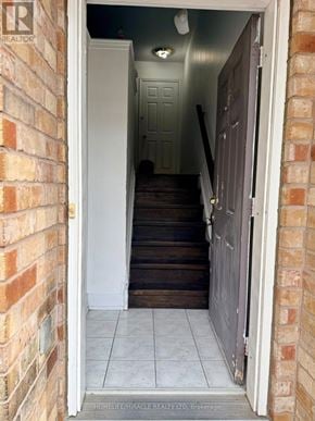 Toronto (Eglinton East) townhouse for rent - A room with a wooden floor and a flat screen TV mounted on the wall.