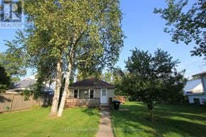 Innisfil apartment for rent - A house with a tree in front of it.