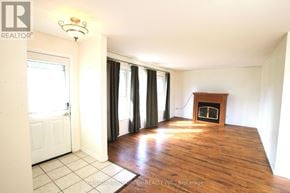 Innisfil apartment for rent - A room with a fireplace and sliding glass doors.