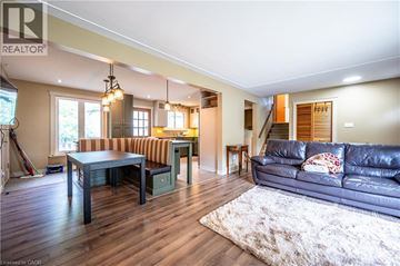 Waterloo apartment for rent - A living room with a black couch and a wooden floor.