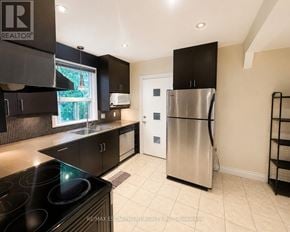 Hamilton (Westcliffe) apartment for rent - A modern kitchen with a stainless steel refrigerator and black cabinets.