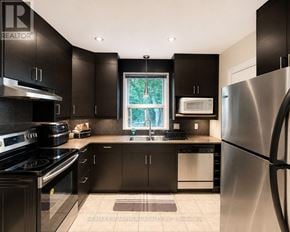 Hamilton (Westcliffe) apartment for rent - A modern kitchen with black cabinets and stainless steel appliances.