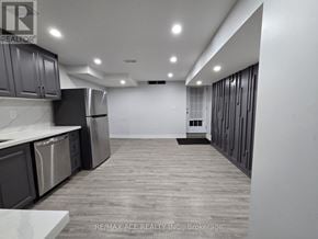 Oshawa (Taunton) apartment for rent - A spacious kitchen with stainless steel appliances and wooden flooring.