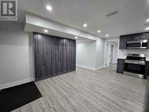 Oshawa (Taunton) apartment for rent - A modern kitchen with a black and white color scheme.