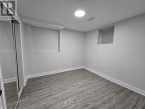 Oshawa (Taunton) apartment for rent - A room with wooden flooring and white walls.
