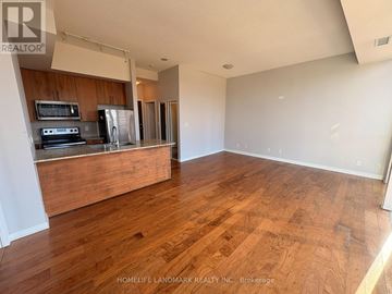 Mississauga (City Centre) condo for rent - A kitchen with wooden floors and a stove top oven.