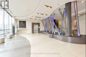 Mississauga (City Centre) condo for rent - A modern hallway with a glass railing and a staircase.